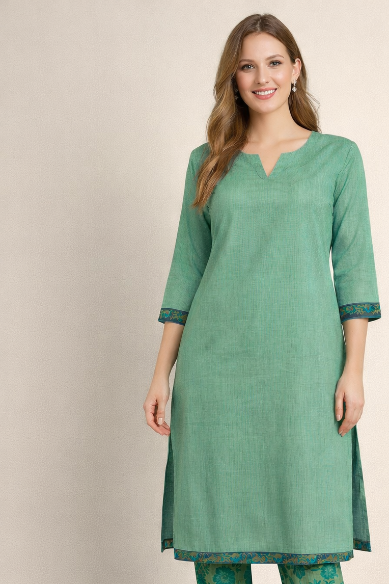 Woman wearing a green kurta and salwar