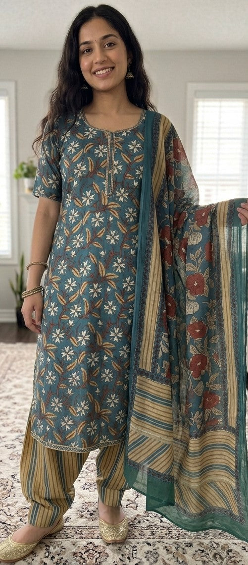 Woman wearing a green printed crepe salwar kameez with matching dupatta