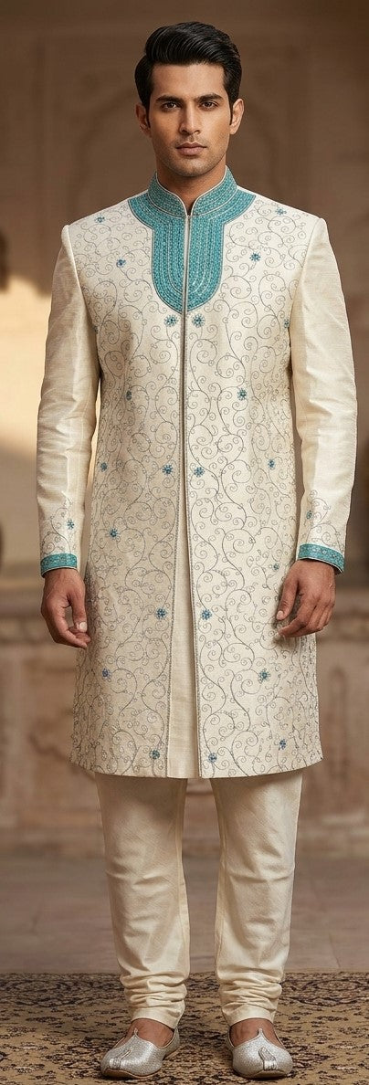 Men's ivory sherwani with floral vine pattern, teal stand collar and teal cuffs