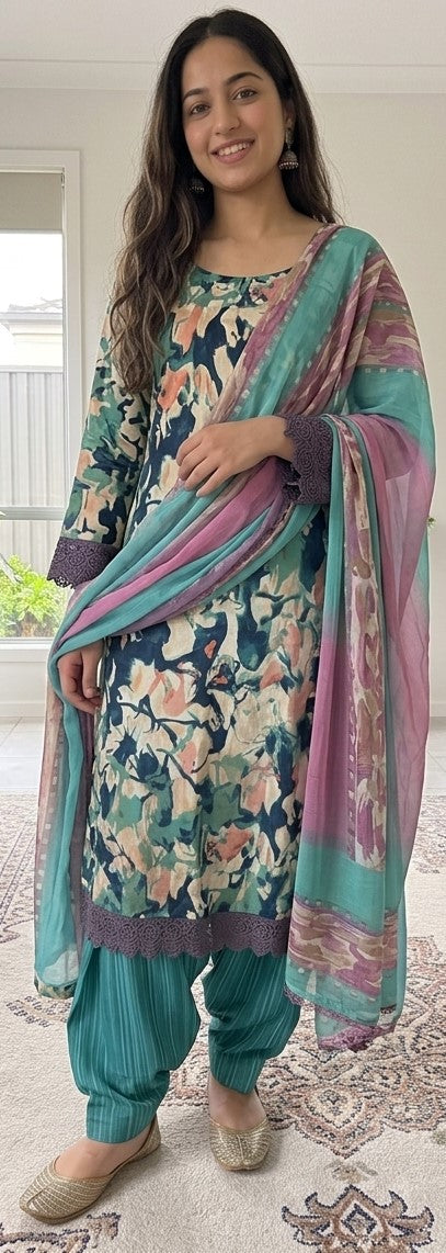 Woman wearing a pink floral printed crepe salwar kameez with matching dupatta
