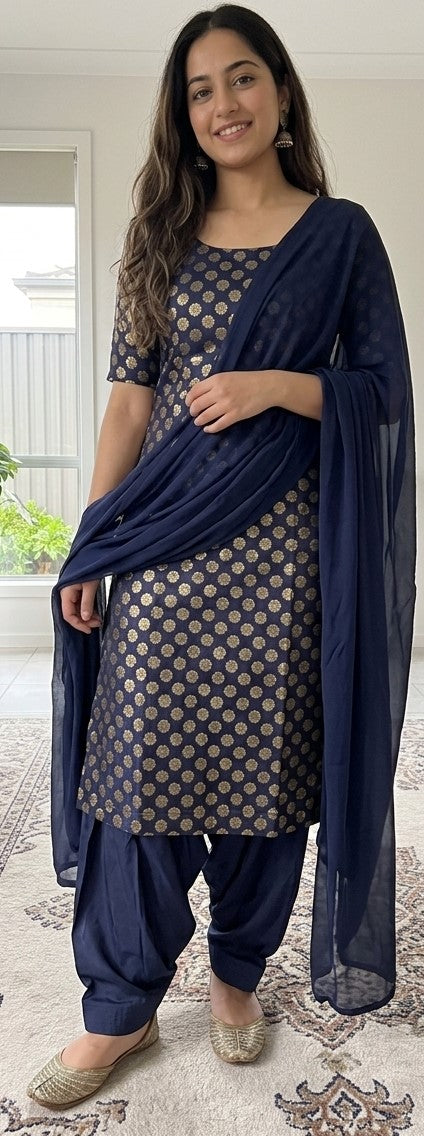 Woman wearing a navy printed short-sleeve dress with matching drape