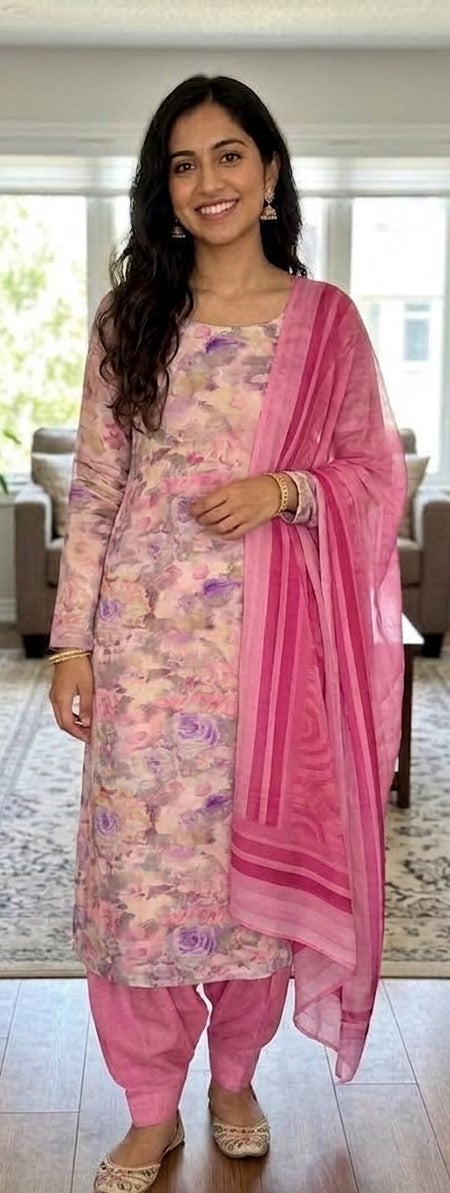 Woman wearing a floral printed crepe salwar kameez with teal and mauve dupatta